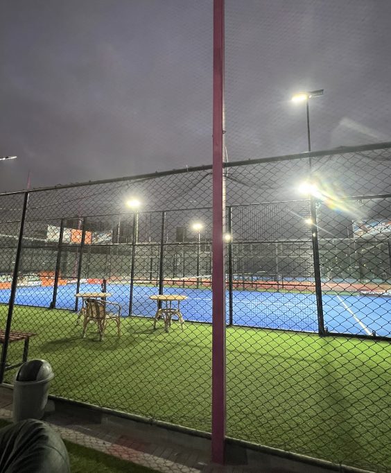 Space Padel courts under floodlights at night